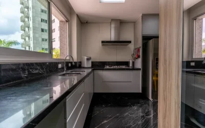 Cozinha gourmet com cooktop a gás, bancada em granito e vista panorâmica da cidade
